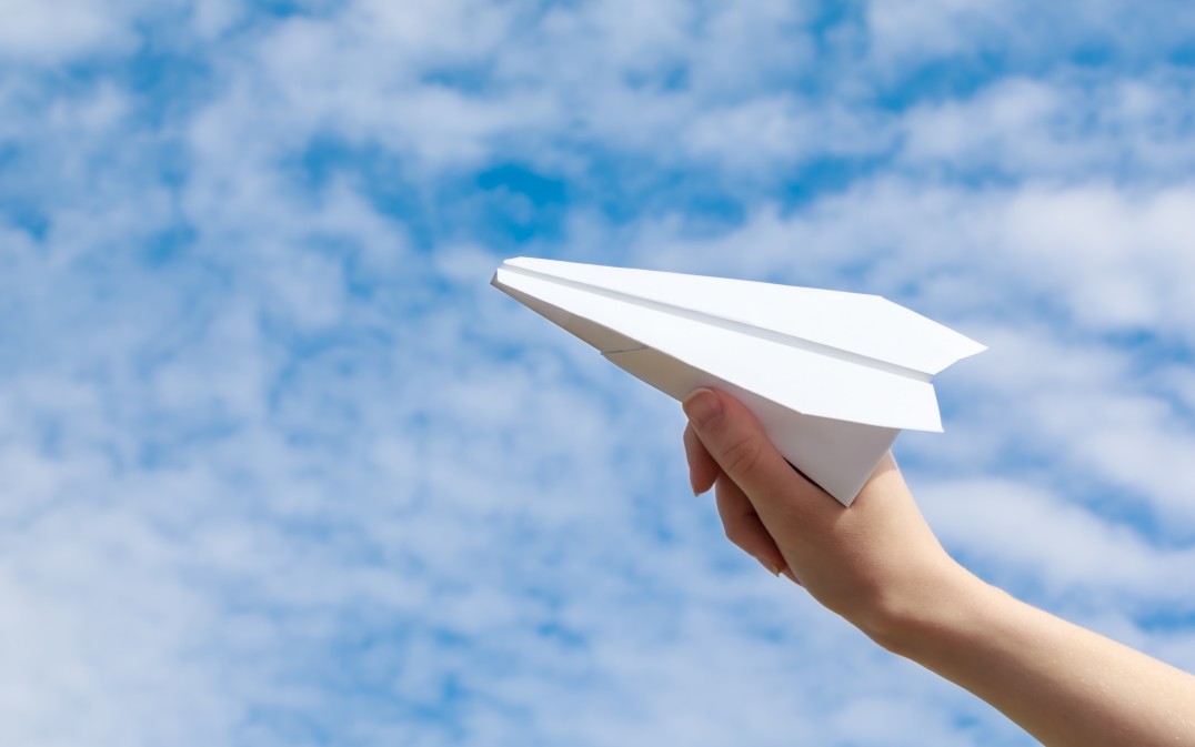 girl-launches-into-a-blue-sky-a-white-paper-airplane-paper-fly-flight-travel-concept-origami-toy-air_t20_wQVEJm